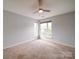 A carpeted bedroom with light gray walls and multiple windows for natural light at 650 Raphael Pl, Charlotte, NC 28205