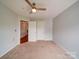 A carpeted bedroom with light gray walls, white trim and a ceiling fan at 650 Raphael Pl, Charlotte, NC 28205