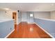 Bonus room with hardwood floors and view of the bathroom and backdoor at 650 Raphael Pl, Charlotte, NC 28205