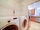 Functional laundry area with washer, dryer, and built-in shelving for storage at 650 Raphael Pl, Charlotte, NC 28205