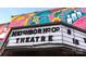 Exterior shot of the Neighborhood Theatre featuring a marquee and colorful mural at 650 Raphael Pl, Charlotte, NC 28205