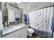 A well-lit bathroom features a granite vanity, ornate mirror, and a tub-shower combination with a decorative curtain at 7123 Meyer Rd, Fort Mill, SC 29715