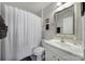 Clean bathroom features a shower-tub, neutral walls, a framed mirror, and a white single sink vanity at 7123 Meyer Rd, Fort Mill, SC 29715