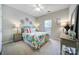 Colorful bedroom with bright linens, carpet, ceiling fan, and dresser at 7123 Meyer Rd, Fort Mill, SC 29715