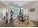 Bright dining area featuring a round table, four chairs, large windows, and stylish decor at 7123 Meyer Rd, Fort Mill, SC 29715