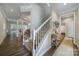 Spacious hallway with staircase, hardwood floors, and views into the living areas at 7123 Meyer Rd, Fort Mill, SC 29715