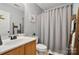 Cozy bathroom featuring a vanity with storage and a shower with a curtain at 7417 Chidley Dr, Charlotte, NC 28269