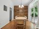 Dining room features a wood accent wall, modern lighting, and sliding doors to the backyard at 7417 Chidley Dr, Charlotte, NC 28269