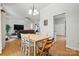 Open-concept dining room with hardwood floors, natural light, and easy access to the living area at 7417 Chidley Dr, Charlotte, NC 28269