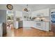 Bright kitchen with white cabinetry, stainless steel appliances, and a view of the backyard at 7417 Chidley Dr, Charlotte, NC 28269