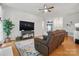 Comfortable living room with a plush recliner, hardwood floors, and large TV at 7417 Chidley Dr, Charlotte, NC 28269