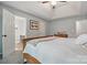 Spacious bedroom featuring a tray ceiling, carpet, and ensuite bathroom at 7417 Chidley Dr, Charlotte, NC 28269