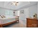 Main bedroom with tray ceiling, carpet, and ensuite bath at 7417 Chidley Dr, Charlotte, NC 28269