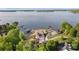 Breathtaking aerial view of a lakeside estate featuring expansive homes, lush greenery, and private docks at 7679 Rabbit Cir, Denver, NC 28037