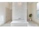 Modern bathroom showcases a freestanding tub, tiled accent wall, and elegant fixtures at 7679 Rabbit Cir, Denver, NC 28037