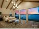 Bedroom featuring water views, wood floors, and comfortable seating area at 7679 Rabbit Cir, Denver, NC 28037