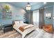Stylish bedroom with blue walls, hardwood floors, and modern decor at 7679 Rabbit Cir, Denver, NC 28037