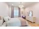 Cozy bedroom features soft lighting, a comfortable bed, and a decorative chandelier at 7679 Rabbit Cir, Denver, NC 28037