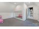 Spacious bonus room with a mirrored wall and ample natural light, perfect for workouts or hobbies at 7679 Rabbit Cir, Denver, NC 28037