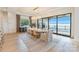 Elegant dining room featuring a waterfront view, chandelier, and access to an outdoor patio with fireplace at 7679 Rabbit Cir, Denver, NC 28037