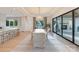 Well-lit dining area with a stone accent wall, stylish furnishings, and large sliding doors to the outside at 7679 Rabbit Cir, Denver, NC 28037