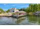 Picturesque waterfront property featuring a covered dock with boat lift, seating, and stunning lake views at 7679 Rabbit Cir, Denver, NC 28037