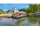 Waterfront property featuring a private dock with covered seating and stunning lake views at 7679 Rabbit Cir, Denver, NC 28037