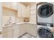 Well-organized laundry room with washer, dryer, sink, ample cabinet space, and stylish countertop at 7679 Rabbit Cir, Denver, NC 28037