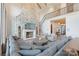 Elegant living room featuring a grand stone fireplace and comfortable sectional seating at 7679 Rabbit Cir, Denver, NC 28037