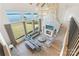Spacious living room with a stone fireplace, floor-to-ceiling windows, and panoramic water views at 7679 Rabbit Cir, Denver, NC 28037