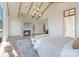 Inviting main bedroom with a stone fireplace, beamed ceilings, and comfortable seating area at 7679 Rabbit Cir, Denver, NC 28037