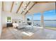 Light-filled main bedroom boasting water views, beamed ceilings, and a serene ambiance at 7679 Rabbit Cir, Denver, NC 28037