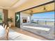 Outdoor patio features a fireplace, ceiling fans, and stunning lake views through sliding glass doors at 7679 Rabbit Cir, Denver, NC 28037