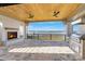 Covered patio with a fireplace, built-in grill, and panoramic views of the lake at 7679 Rabbit Cir, Denver, NC 28037