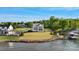 Stunning waterfront home with expansive lawn, lush landscaping, and private dock, perfect for outdoor enjoyment at 7679 Rabbit Cir, Denver, NC 28037