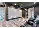 Comfortable theater room with projector, screen, and seating for the ultimate movie night experience at 7679 Rabbit Cir, Denver, NC 28037