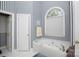 Relaxing bathroom with a soaking tub and striped wallpaper at 777 Sanside Dr, York, SC 29745