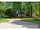 View of the detached garage and a long driveway surrounded by mature trees at 777 Sanside Dr, York, SC 29745