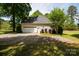 Traditional home exterior features a 2-car garage and lush, mature landscaping at 777 Sanside Dr, York, SC 29745
