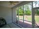 View from screened porch with ceiling fan to expansive backyard with wood deck at 777 Sanside Dr, York, SC 29745