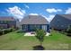 Beautiful backyard featuring a fire pit on a paved patio and a lush lawn at 8000 Millbridge Pkwy, Waxhaw, NC 28173