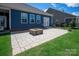 Beautiful backyard with a paved patio and modern fire pit, perfect for outdoor entertaining at 8000 Millbridge Pkwy, Waxhaw, NC 28173