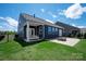 Beautiful backyard with patio, fire pit, and porch swing for outdoor enjoyment at 8000 Millbridge Pkwy, Waxhaw, NC 28173