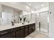 Double sink bathroom with modern fixtures, large mirrors, and separate shower at 8000 Millbridge Pkwy, Waxhaw, NC 28173