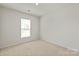 Bright bedroom with neutral carpet, natural light from a window, and plenty of space at 8000 Millbridge Pkwy, Waxhaw, NC 28173