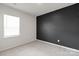Minimalist bedroom featuring plush carpet, a window with blinds, and a painted accent wall at 8000 Millbridge Pkwy, Waxhaw, NC 28173