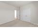 Comfortable bedroom with carpet, a large closet, and open doorway to an adjacent space at 8000 Millbridge Pkwy, Waxhaw, NC 28173