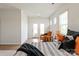 Relaxing bedroom featuring a comfortable chair, natural light, and neutral decor at 8000 Millbridge Pkwy, Waxhaw, NC 28173
