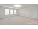 Expansive bonus room with neutral carpet, large windows, and ample space for entertaining at 8000 Millbridge Pkwy, Waxhaw, NC 28173