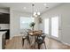 Cozy dining area with modern lighting and easy access to the kitchen and outdoor patio at 8000 Millbridge Pkwy, Waxhaw, NC 28173